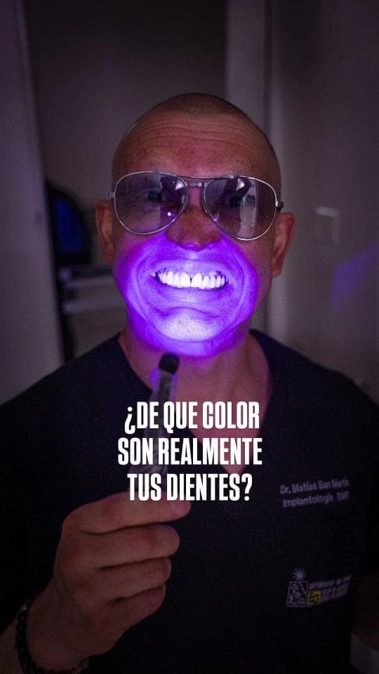Dr. Matías San Martín mostrando la fluorescencia de los dientes con luz ultravioleta